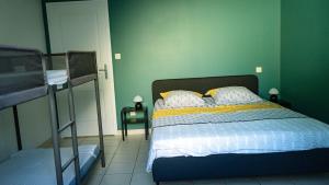 a bedroom with a bed and two bunk beds at La Maison Du Vigneron in Gaillac