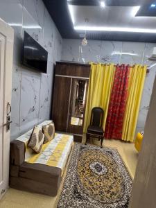 a living room with a couch and a chair at Homestay, hotel at Pathankot in Pathānkot