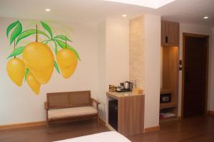 a room with a painting of mangoes on the wall at Katunggan Cove Resort in Nueva Valencia