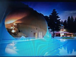 a pool with a domed building with a fire in it at KASTELY ViLLA MISKOLCTAPOLCA in Miskolc +3 photos