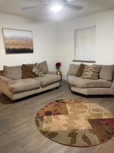 a living room with two couches and a rug at Stylish Decatur Retreat in Decatur