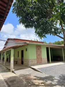 a green building with a tree in front of it at Bom Viver Pousada-Viçosa do Ceará -CE in Viçosa do Ceará +12 photos