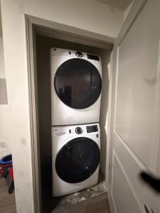 a microwave sitting on top of a washer and dryer at Stylish Decatur Retreat in Decatur
