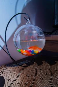 a glass bowl with a colorful fish in it at Beryl's Haven in Marimbeti