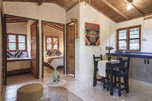 a room with a bed and a table and chairs at Olimpo Interior in Santa Elena
