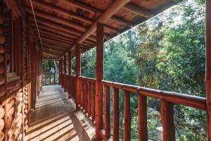 a wooden balcony of a cabin in the woods at Olimpo Interior in Santa Elena