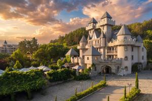 a castle on top of a hill with trees at Royal Valentina Castle in Ognyanovo