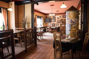 a dining room with tables and chairs in a restaurant at Hotel Westrich in Baumholder