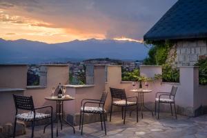 a patio with chairs and tables with a view of mountains at Royal Valentina Castle in Ognyanovo