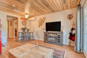 a living room with a tv and a fireplace at Fox Den Cozy Mountain Apt In GMF in Green Mountain Falls
