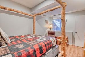 a bedroom with a wooden bed and a chair at Fox Den Cozy Mountain Apt In GMF in Green Mountain Falls