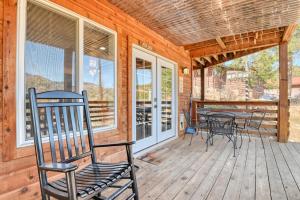a porch with chairs and a table on it at Fox Den Cozy Mountain Apt In GMF in Green Mountain Falls