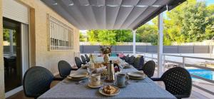 a dining table with chairs and a blue table cloth at Villa Montesol in La Drova