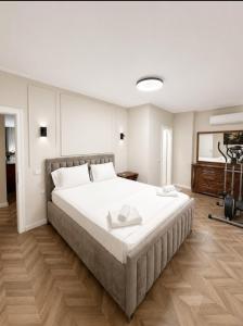 a bedroom with a large white bed in a room at Prince Hotel in Tirana +29 photos