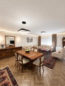 a living room with a table and a couch at Prince Hotel in Tirana