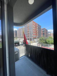 a balcony with a view of a city at Leni Apartment in Patza-Kuqani