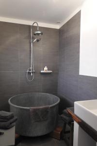 a bathroom with a large tub and a sink at Le Piano in Biesles