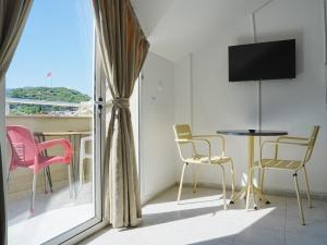 a room with a balcony with a table and chairs at Asya Blue Apartments in Marmaris
