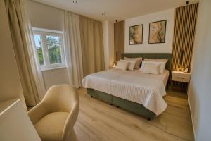 a bedroom with a bed and a chair in it at Villa de Pucci in Žminj +34 photos