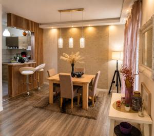 a kitchen and dining room with a table and chairs at New Moment in Žarkovo
