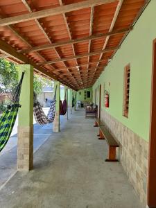 a room with hammocks hanging from the ceiling at Bom Viver Pousada-Viçosa do Ceará -CE in Viçosa do Ceará