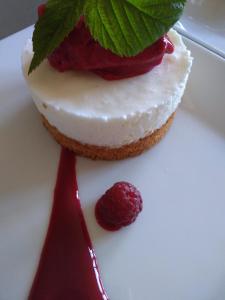 a piece of cake with a raspberry on a white plate at Le Piano in Biesles +21 photos