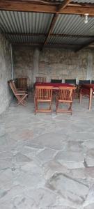 a group of wooden tables and benches in a building at Lebentera camp in Narok