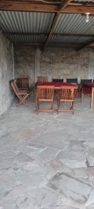 a group of wooden tables and benches in a building at Lebentera camp in Narok