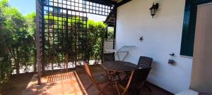 a balcony with a table and chairs on a patio at Villette di Torre Inserraglio in Nardò