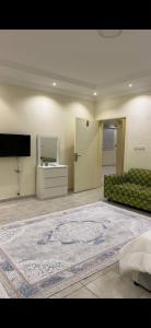 a large living room with a couch and a television at hostel in Obhur in Jeddah