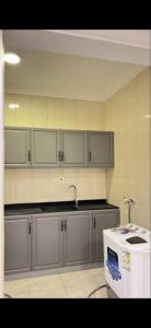 a kitchen with stainless steel cabinets and a sink at hostel in Obhur in Jeddah +3 photos
