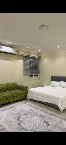 a bedroom with a large bed and a rug at hostel in Obhur in Jeddah