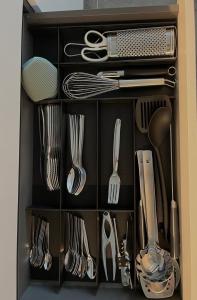 a drawer filled with utensils and silverware at ALandGIO Smart Stay in Cavallino-Treporti