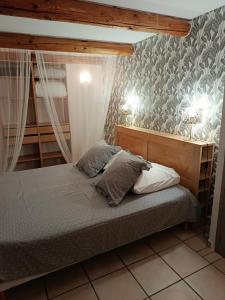 a bedroom with a bed with two pillows on it at Gite du riage classé 3 étoiles près d 'Anduze , Cévennes in Saint-Christol-lès-Alès +45 photos