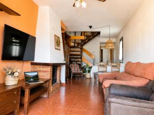 a living room with a couch and a fireplace at Duplex La Valle Ordesa-Ainsa in Laspuña
