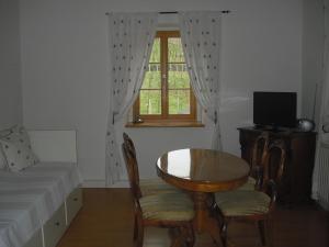 a room with a table and chairs and a window at Weingut Mariaberg in Meißen