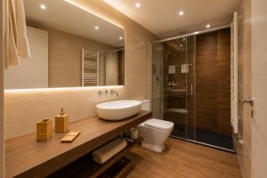 a bathroom with a sink and a toilet and a shower at El Gresol - Naturaleza y Relax in Senant +28 photos