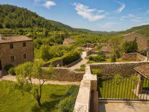 a view of a village with a fence and trees at El Gresol - Naturaleza y Relax in Senant