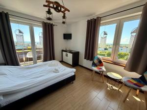 a hotel room with a bed and a view of the bur landmarks at Angelika in Swarzewo +88 photos
