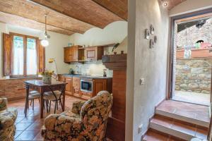 a kitchen and dining room with a table and chairs at Le ginestre 10 in Murlo