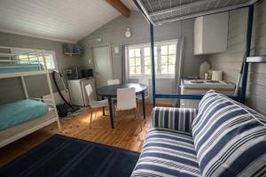 a living room with a couch and a table in a room at Turifoss Camping Cabin 2 in Svedjan +31 photos
