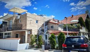 a car parked in front of a house at Apartmani BALKAN in Sjenica