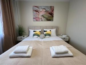 a bedroom with a bed with two towels on it at DeMar Apart Sun in Lviv