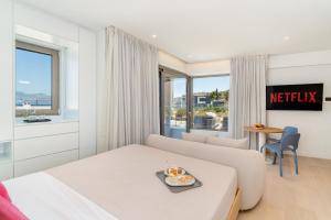 a hotel room with a bed and a view of the ocean at NOMIA Seaside Living in Agios Nikolaos