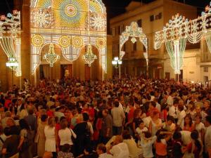 a large crowd of people in a building with lights at Nonna Rosa's Apartment in Pisticci +20 photos