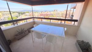 a table and chairs on a balcony with a view at Seaside one bedroom apartment with terraces, garage & swimming pool in Cascais