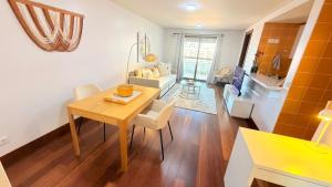 a living room with a table and a dining room at Seaside one bedroom apartment with terraces, garage & swimming pool in Cascais
