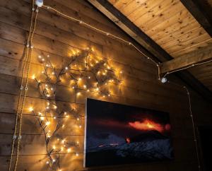 a wall with christmas lights on a wall at Etna Essence Chalet in Trecastagni