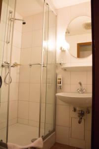a bathroom with a shower and a sink at Hotel Westrich in Baumholder
