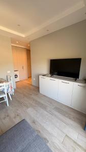 a living room with a large flat screen tv at Apartment in Golem in Golem